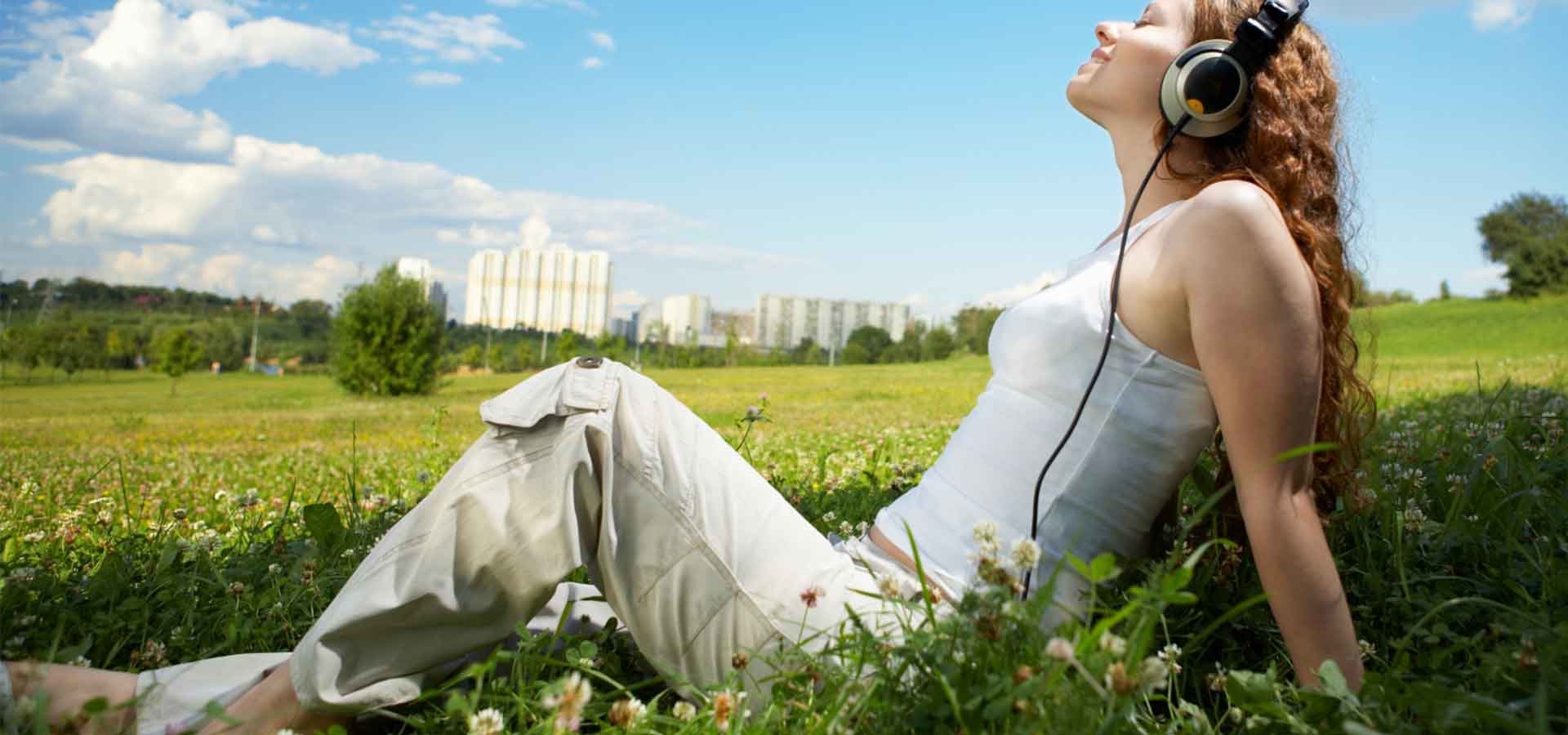 Lady in field with headphones